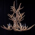 Aspen 2-tier mule deer antler chandelier in natural finish with ten lit candle-style bulbs
