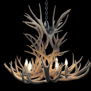 Deerlodge mule deer antler chandelier in natural antler finish with lit candle-style bulbs, studio shot