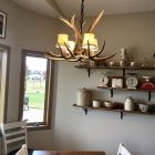 Osprey Mule Deer Antler Chandelier with fabric shades installed over a breakfast nook