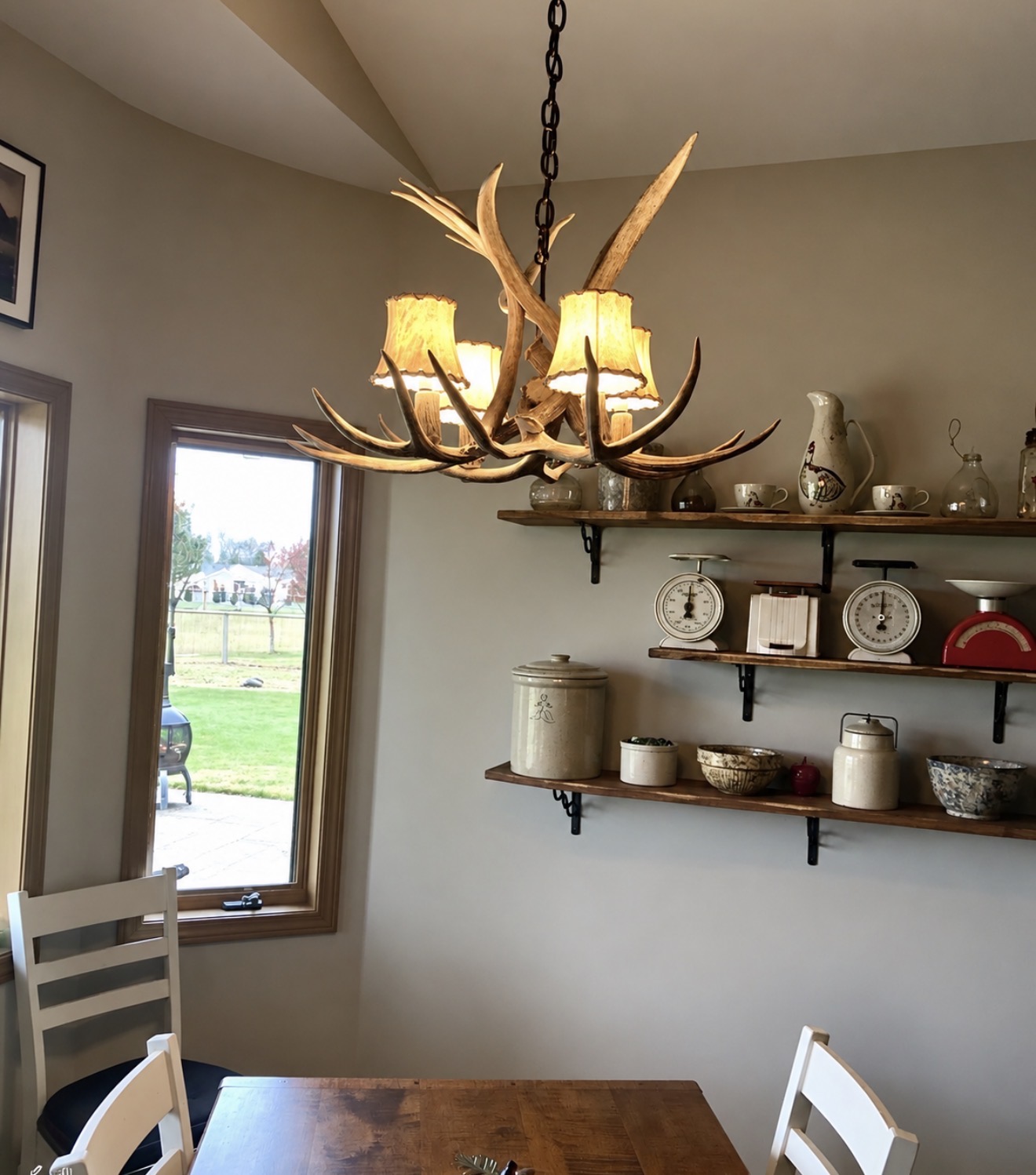 Osprey Mule Deer Antler Chandelier with fabric shades installed over a breakfast nook