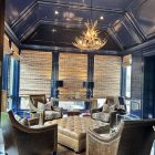 Deerlodge mule deer antler chandelier hanging from an octagonal navy blue ceiling above a seating area