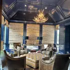 Deerlodge mule deer antler chandelier hanging from an octagonal navy blue ceiling above a seating area