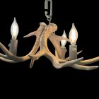 Fawn Whitetail Antler Chandelier in natural finish with three lit candle-style bulbs