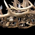 Close detail of the Gallatin Elk and Mule Deer Antler Chandelier showing antler joinery and light fixtures