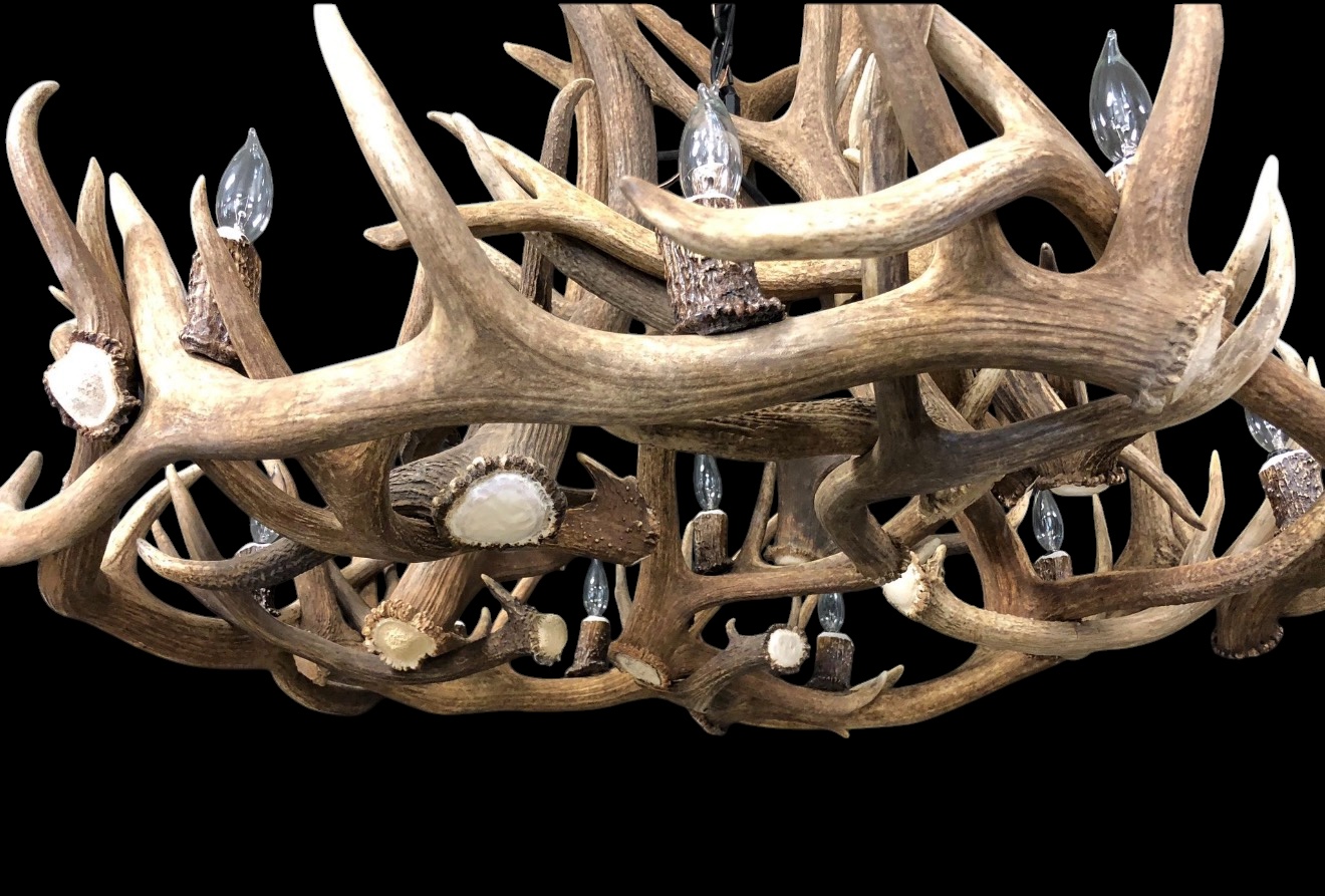 Close detail of the Gallatin Elk and Mule Deer Antler Chandelier showing antler joinery and light fixtures