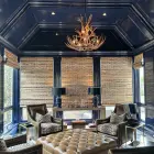Deerlodge mule deer antler chandelier viewed from across an octagonal navy blue sitting room