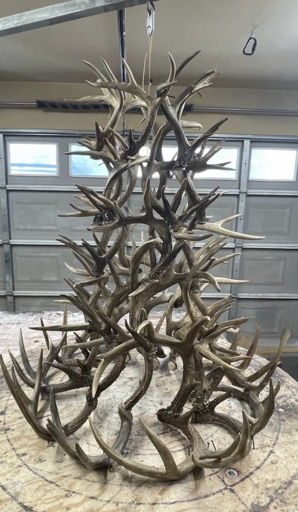 First version of the six-tier chandelier on the workbench, built entirely from the customer's own whitetail antler