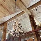 Salish Elk & Mule Deer Antler Chandelier lit in a vaulted timber-frame great room