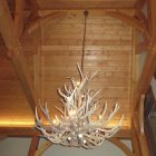 Salish Elk & Mule Deer Antler Chandelier hanging in a vaulted timber-frame entry