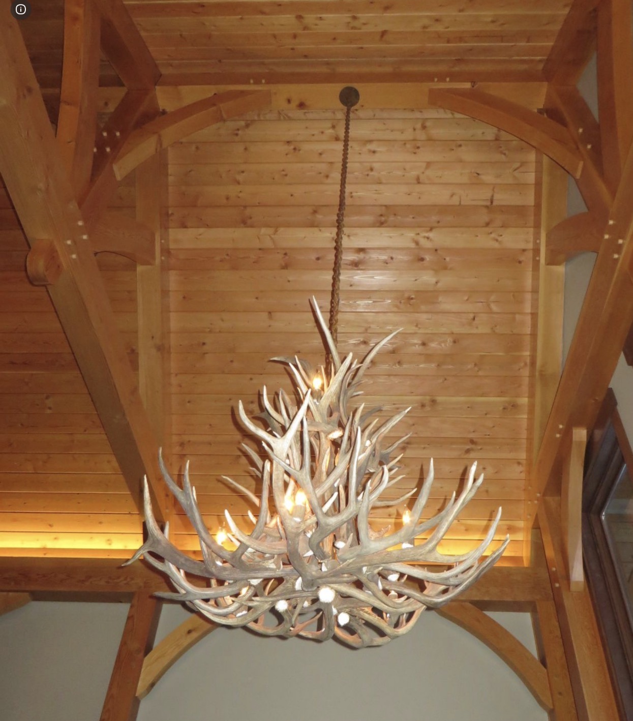 Salish Elk & Mule Deer Antler Chandelier hanging in a vaulted timber-frame entry