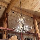 Salish Elk & Mule Deer Antler Chandelier lit above a vaulted great room loft