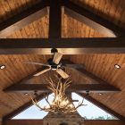 Snowcrest Elk Antler Chandelier hanging in a vaulted timber-beam great room