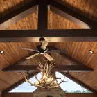 Snowcrest Elk Antler Chandelier hanging in a vaulted timber-beam great room