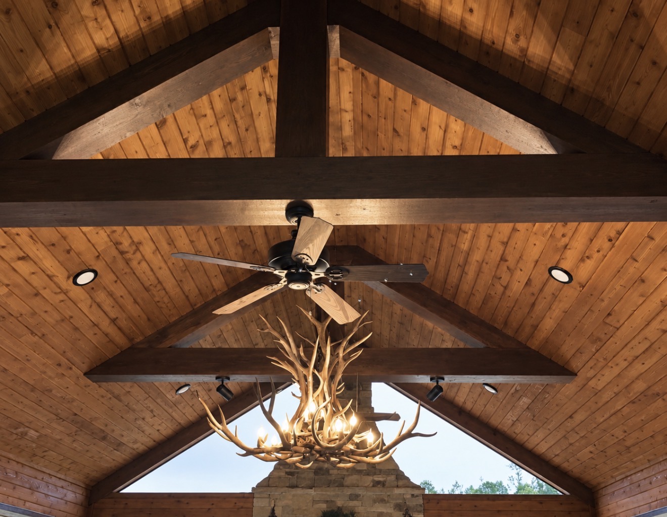 Snowcrest Elk Antler Chandelier hanging in a vaulted timber-beam great room