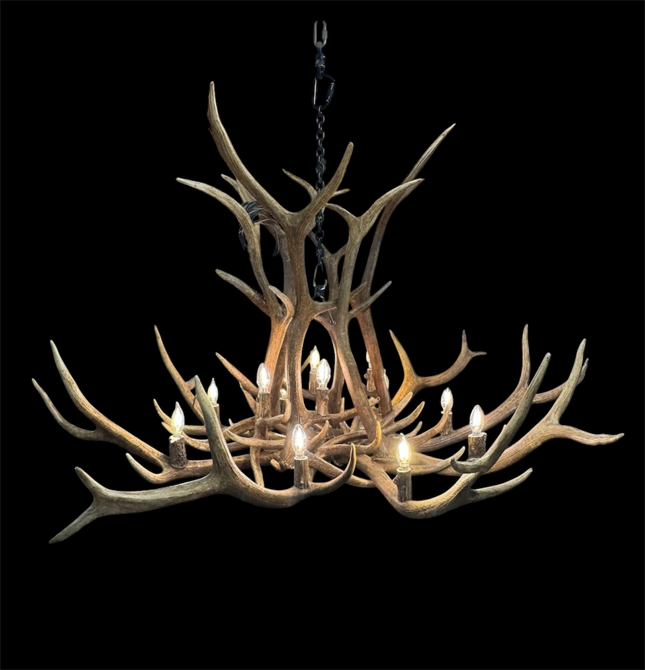 Snowcrest Elk Antler Chandelier - Lit, Black Background Snowcrest Elk Antler Chandelier lit studio photo on black background