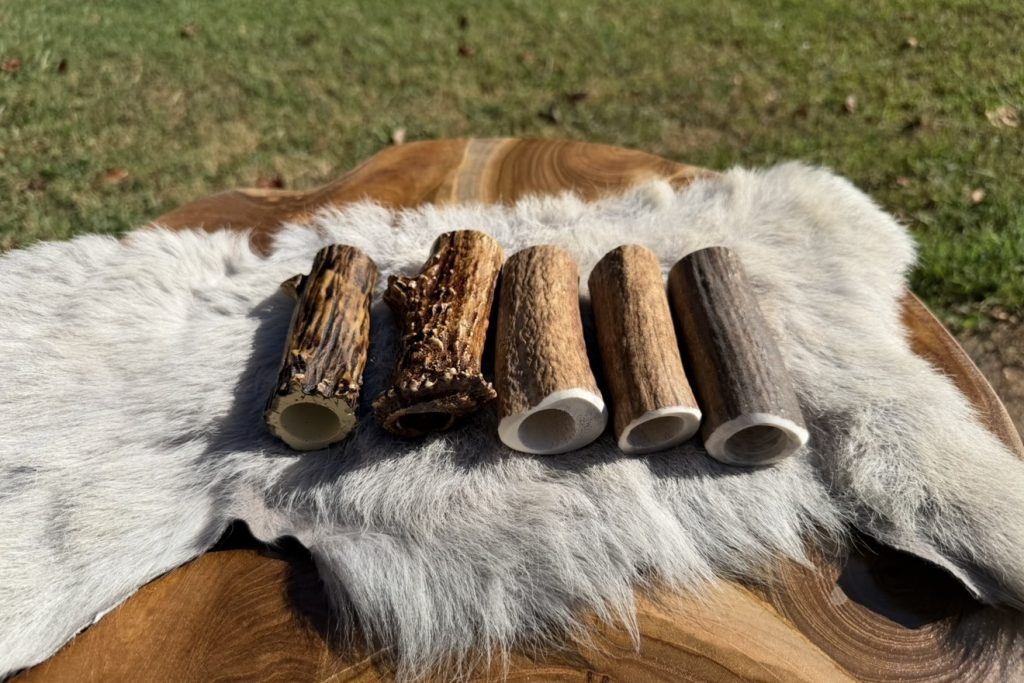 Real antler socket covers next to resin socket covers, showing the natural color variation of genuine antler compared to the consistent look of resin