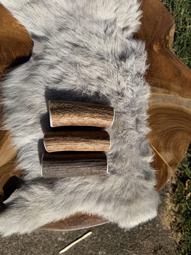 Three real antler socket covers side by side showing natural color and grain variation