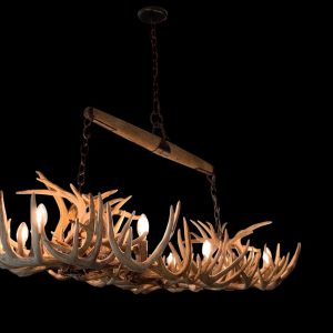 Luxury whitetail antler rectangular chandelier lit and hanging, front angle view