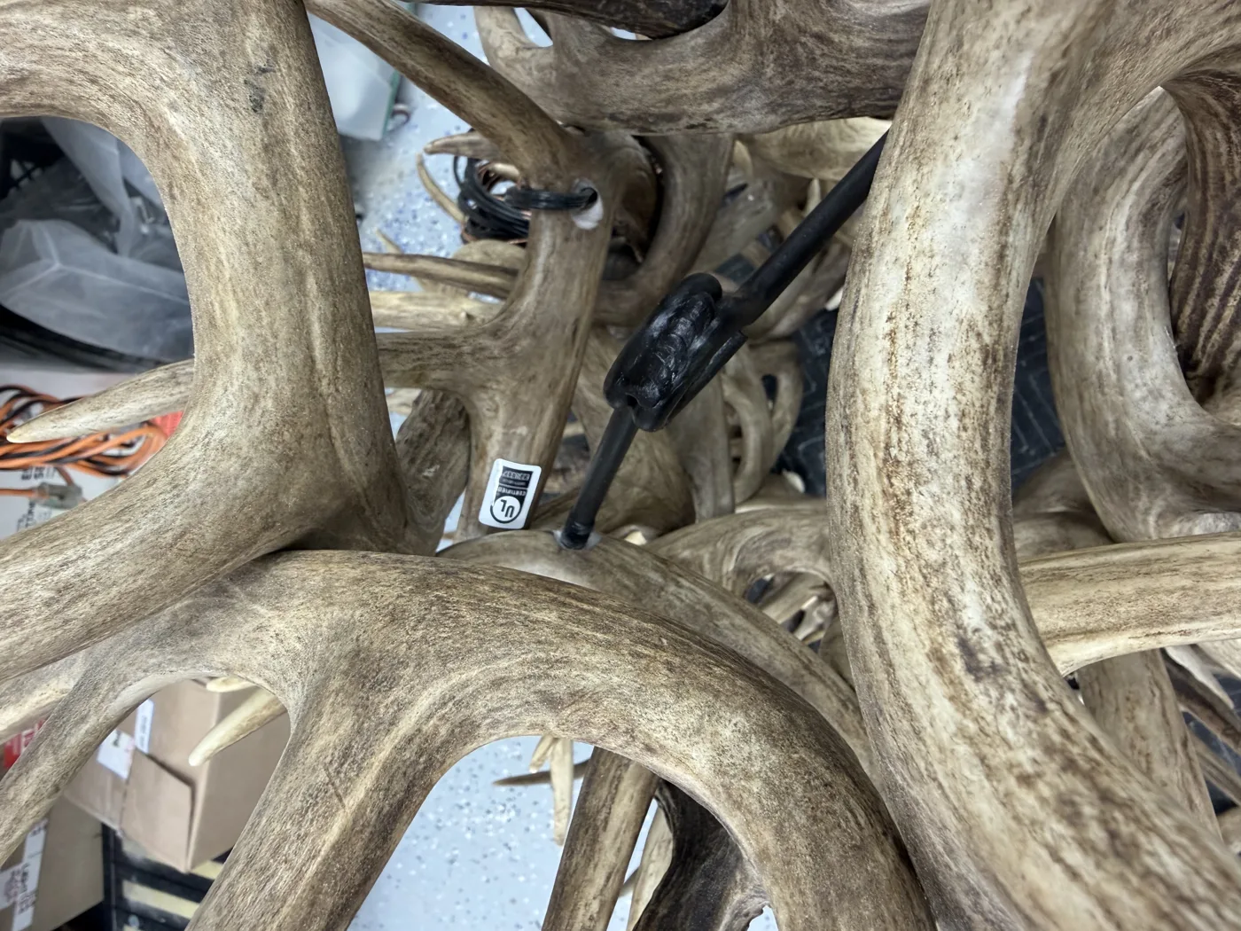 UL certification label and concealed wiring visible inside the antler frame of a finished chandelier