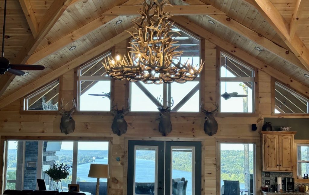 Large six-tier whitetail chandelier built from a customer's own shed antlers, hanging in a vaulted great room