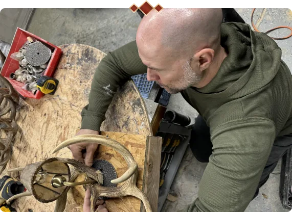 Craftsman building custom antler chandeliers by hand