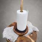 Antler paper towel holder with a brown wood slice base holding a paper towel roll