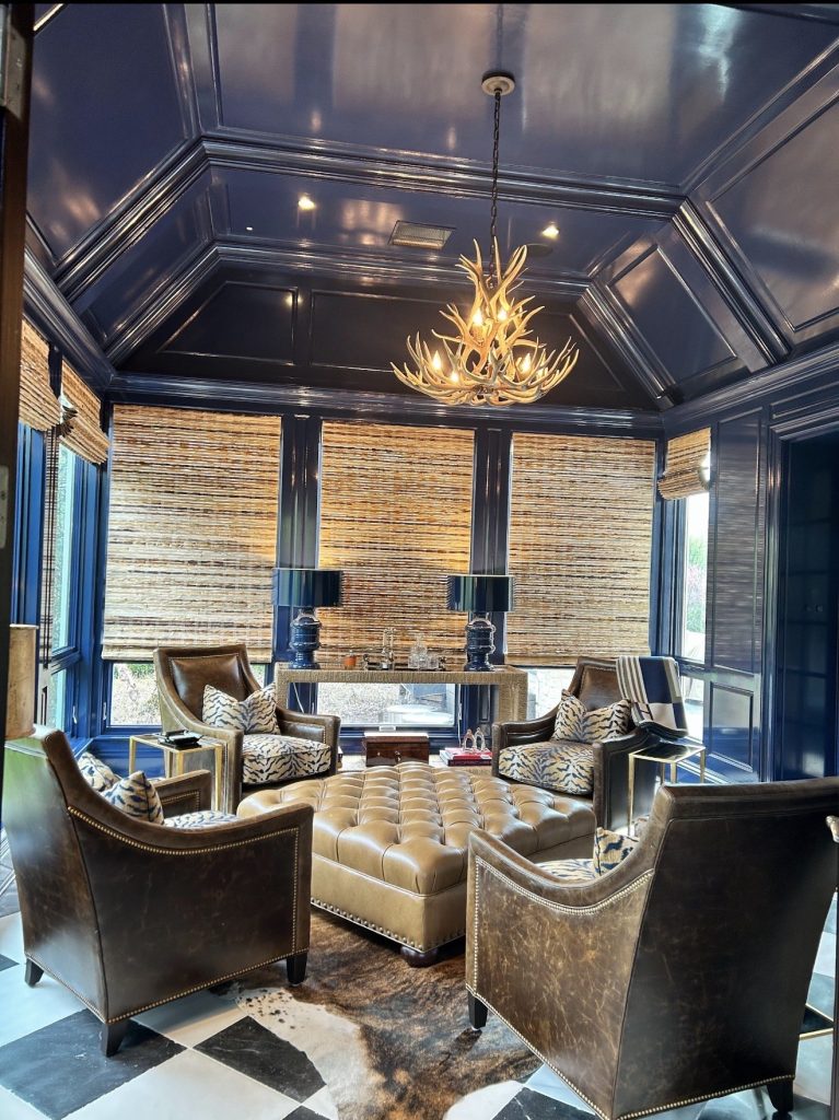 Deerlodge antler chandelier above leather club chairs