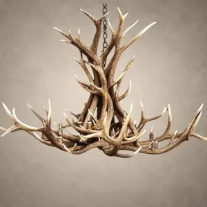 Snowcrest elk antler chandelier with a tall twisted center of Rocky Mountain elk antler and a wide sweeping ring of antler around 12 candle-style lights, hanging from an iron chain