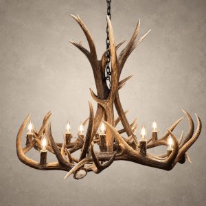 Big Sky elk and mule deer antler chandelier lit with candelabra bulbs, tall antler center and wide ring of antler, front view