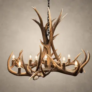 Big Sky elk and mule deer antler chandelier lit with candelabra bulbs, tall antler center and wide ring of antler, front view