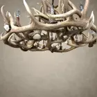 Close-up of the Gallatin chandelier showing layered elk and mule deer antler, natural antler burrs and candle sockets