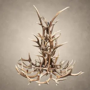 Salish elk and mule deer antler chandelier lit with candelabra bulbs, layered elk and mule deer antler in a tall western silhouette