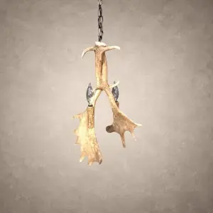 Heron fallow deer antler pendant light with two candle-style lights and palmated fallow antler hanging from an iron chain