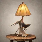 Moose antler table lamp – Kenai: real moose antler base with a lit rawhide shade, shown on a wood side table
