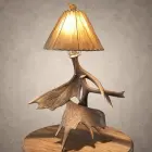 Moose antler table lamp – Kenai: real moose antler base with a glowing rawhide shade and pull-chain switch