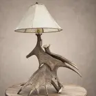 Kenai moose antler table lamp with stacked moose antler paddles and a laced rawhide shade on a wood side table