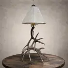 Mule deer antler table lamp – Madison: real mule deer antler base with a rawhide shade and antler-tip pull chain, on a wood side table