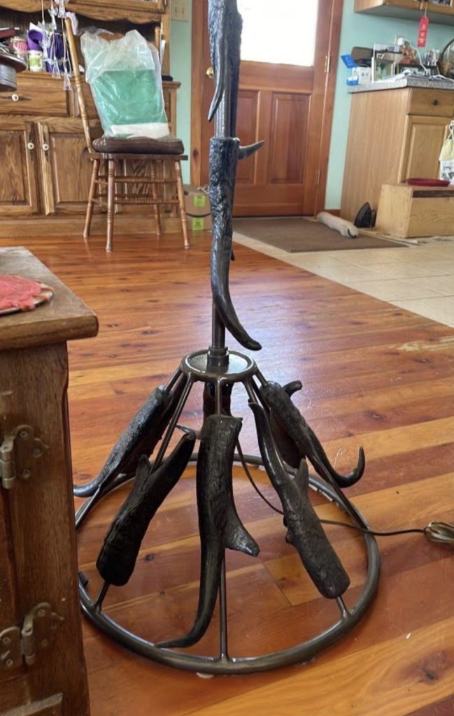 Close-up of pronghorn horns on welded lamp base
