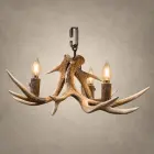 Single Tier Fawn whitetail antler chandelier shown with its iron ceiling hook and three lit candle-style bulbs