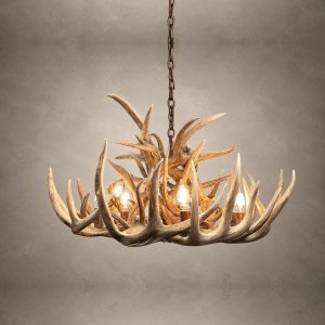Single Tier Whitetail antler chandelier lit with candle-style bulbs, a ring of natural whitetail antler beneath a cluster of upswept tines, hanging from an iron chain