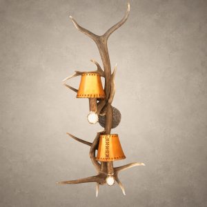 Elk and whitetail antler wall sconce – Teton: 2-light real antler sconce with rawhide-style shades, antler socket covers and hammered iron back plate