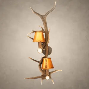 Elk and whitetail antler wall sconce – Teton: 2-light real antler sconce with rawhide-style shades, antler socket covers and hammered iron back plate