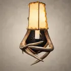 Whitetail antler wall sconce – Kootenai with the hammered steel back plate upgrade, crossed whitetail antlers and a lit rawhide shade